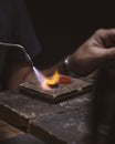 Close-up of goldsmiths using fire to make rings, in artisanal work.