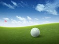 Close up golf ball on green grass field and red golf flag on green fairway with beautiful blue sky Royalty Free Stock Photo