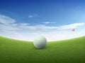 Close up golf ball on green grass field and red golf flag on green fairway with beautiful blue sky Royalty Free Stock Photo