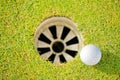 Close-up of golf ball near hole Royalty Free Stock Photo