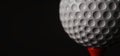 Close-Up of Golf Ball on Tee with Dark Background Royalty Free Stock Photo
