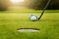 close up golf club and golf ball on green grass with sunrise background Royalty Free Stock Photo