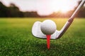 close up golf club and golf ball on green grass with sunrise background Royalty Free Stock Photo