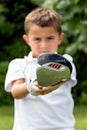 Close-up of golf driver club head held by little boy golfer - se