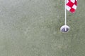 Close up of golf driving range. Hole and red flag on green grass Royalty Free Stock Photo