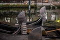 Close up of gondalas parked on a canal in Venice showing the decorative ferro / iron at the bow of the boats and the risso. Royalty Free Stock Photo