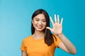 Close-up good-looking friendly cheerful asian woman raise palm show number five, fifth, smiling joyfully, describe how Royalty Free Stock Photo