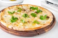 Close up gourmet pizza with gorgonzola and porcini white mushrooms decorated with parsley leaves on the wooden board Royalty Free Stock Photo