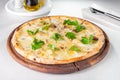 Close up gourmet pizza with gorgonzola and porcini white mushrooms decorated with parsley leaves on the wooden board on the served Royalty Free Stock Photo