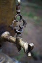 Close-up graceful faucet of an old copper samovar on a blurred forest background, selective focus Royalty Free Stock Photo