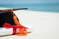 Close up Graduation cap and certificated on the beach