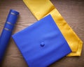 Close Up Of Graduation Robe, Mortar Board and Qualification Or Degree