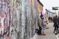 Graffiti and people at the East Side Gallery in Berlin Royalty Free Stock Photo