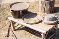 Grains paddy rice in wood basket tray and rice grinder rock outdoor background