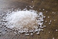 Close-up of Grains of Seasalt on a Dark Wooden Chopping Board Royalty Free Stock Photo