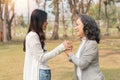 Close-up of granddaughter consoling her senior grandmother and touching hand when in park Royalty Free Stock Photo