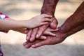Grandfather hand and asian child girl hand for familly background