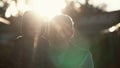 CLose-up of grandfather holding grandson on hands, hugs and kiss boy on cheek. Old man standing outdoor in sunlight. 4K Royalty Free Stock Photo