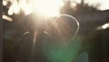 CLose-up of grandfather holding grandson on hands, hugs and kiss boy on cheek. Old man standing outdoor in sunlight. 4K Royalty Free Stock Photo