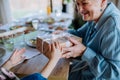 Close-up of grandmother giving gift to her granddaughter during Easter dinner. Royalty Free Stock Photo