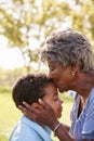 Close Up Of Grandmother Kissing Grandson In Park Royalty Free Stock Photo