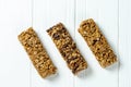 Close up on Granola Bar isolated on white wooden background. Healthy sweet dessert snack. Energy bar of muesli. Granola for