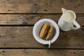 Granola bar and milk on wooden table Royalty Free Stock Photo