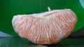 Close-up of a grapefruit that is peeled and the orange pulp is visible Royalty Free Stock Photo