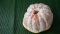 Close-up of a grapefruit that is peeled and the orange pulp is visible Royalty Free Stock Photo