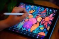 Close up of a Graphic Designer hand drawing on a digital tablet