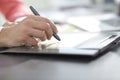 Close up. a graphic designer uses a graphics tablet sitting at D