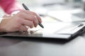 Close up. a graphic designer uses a graphics tablet sitting at Desk in Studio