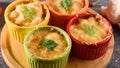 Close-up of gratin with chicken, mushrooms, under cheese crust in multicolored cocoanuts on wooden Board