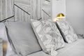 Close up of gray cushions on bed in cozy bedroom Royalty Free Stock Photo