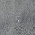 Close-up of Gray Fabric Texture with Small Hole Royalty Free Stock Photo