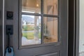 Close up of gray front door of home with glass panels black handle and keyhole Royalty Free Stock Photo