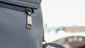 Close up of gray leather bag zipper