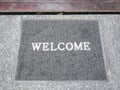 Close-up Gray Mat with White Welcome Text Label