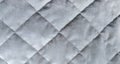 Close-up of gray silk quilted fabric for background. The perfect backdrop for your presentation