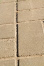 Close-up gray square pavement slabs.