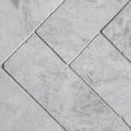 Gray floor tiles, herringbone pattern, close-up