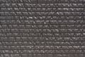 Close up gray texture of quilted striped fabric. Abstract textile background
