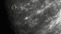 Close-up grayscale image of the moon's surface showing craters, impact, and texture Royalty Free Stock Photo