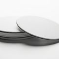 Stack of Round White Coasters with Black Edges on White Background drink coaster circular Royalty Free Stock Photo