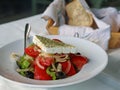 Close up of greek salad with fresh tomatos, onions, feta cheese and black olives Royalty Free Stock Photo