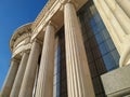 Close up of Greek style pillars and columns old fashioned style historical white architecture building with modern glass windows Royalty Free Stock Photo