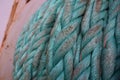 Close up on green aged manila rope heaved up on working drum of forward port side mooring winch. Royalty Free Stock Photo