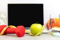 Close up green apple and dumbbell. Healthy snack for diet planning for working in office Royalty Free Stock Photo