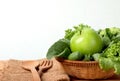 Close up the green apple with mixed green vegetable in basket and a wooden fork and spoon for healthy organic green food concept Royalty Free Stock Photo
