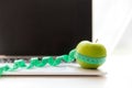 Close up green apple and tape measure. Healthy snack for diet planning for working in office. Royalty Free Stock Photo